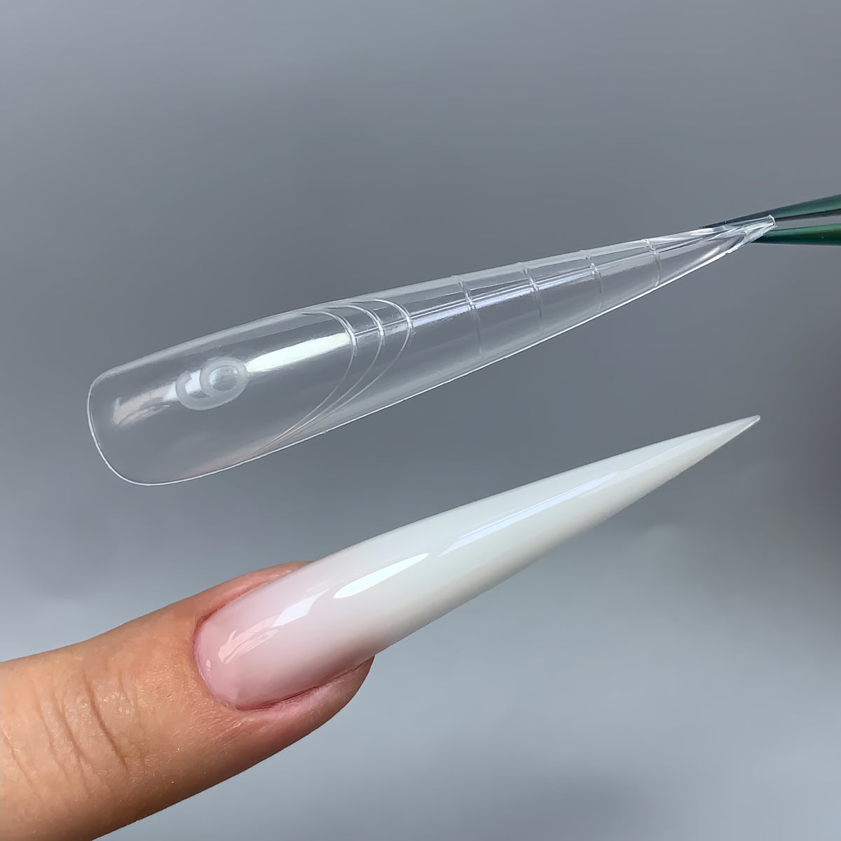 C16 extra long stiletto nail forms with sharp centered point, close-up view
