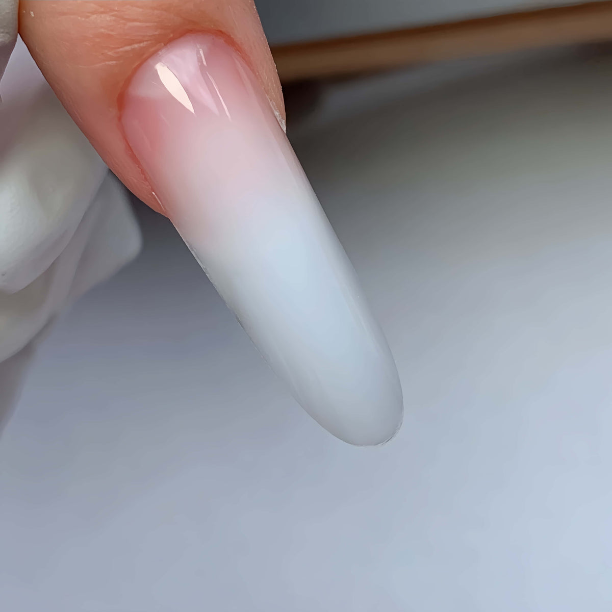 Finished natural 3.5 cm oval gel nail extensions made with COZURU C28 dual forms
