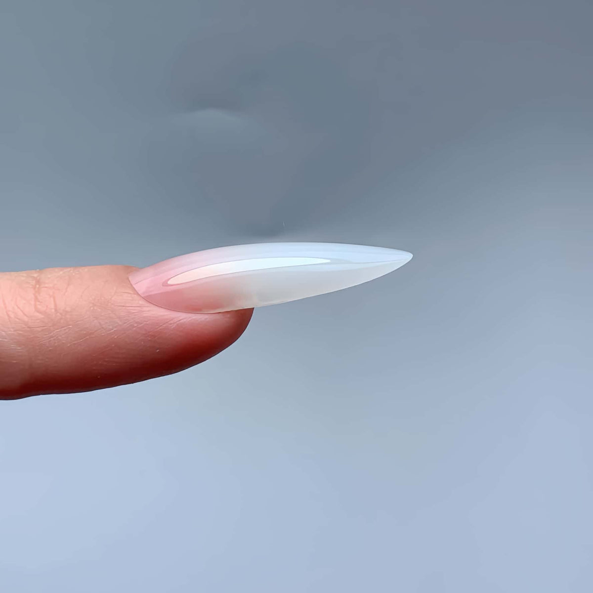 Lateral side profile view showing natural C-curve and subtle apex of COZURU C29 almond nail extension