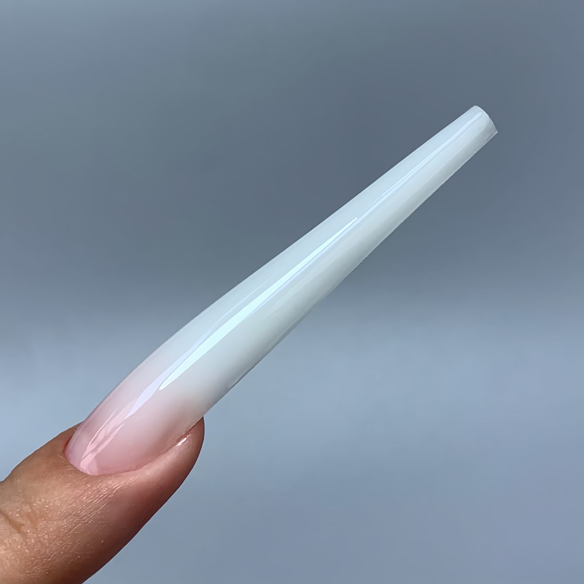Side view of a finished square arch nail made with COZURU C09 forms, showing the raised apex